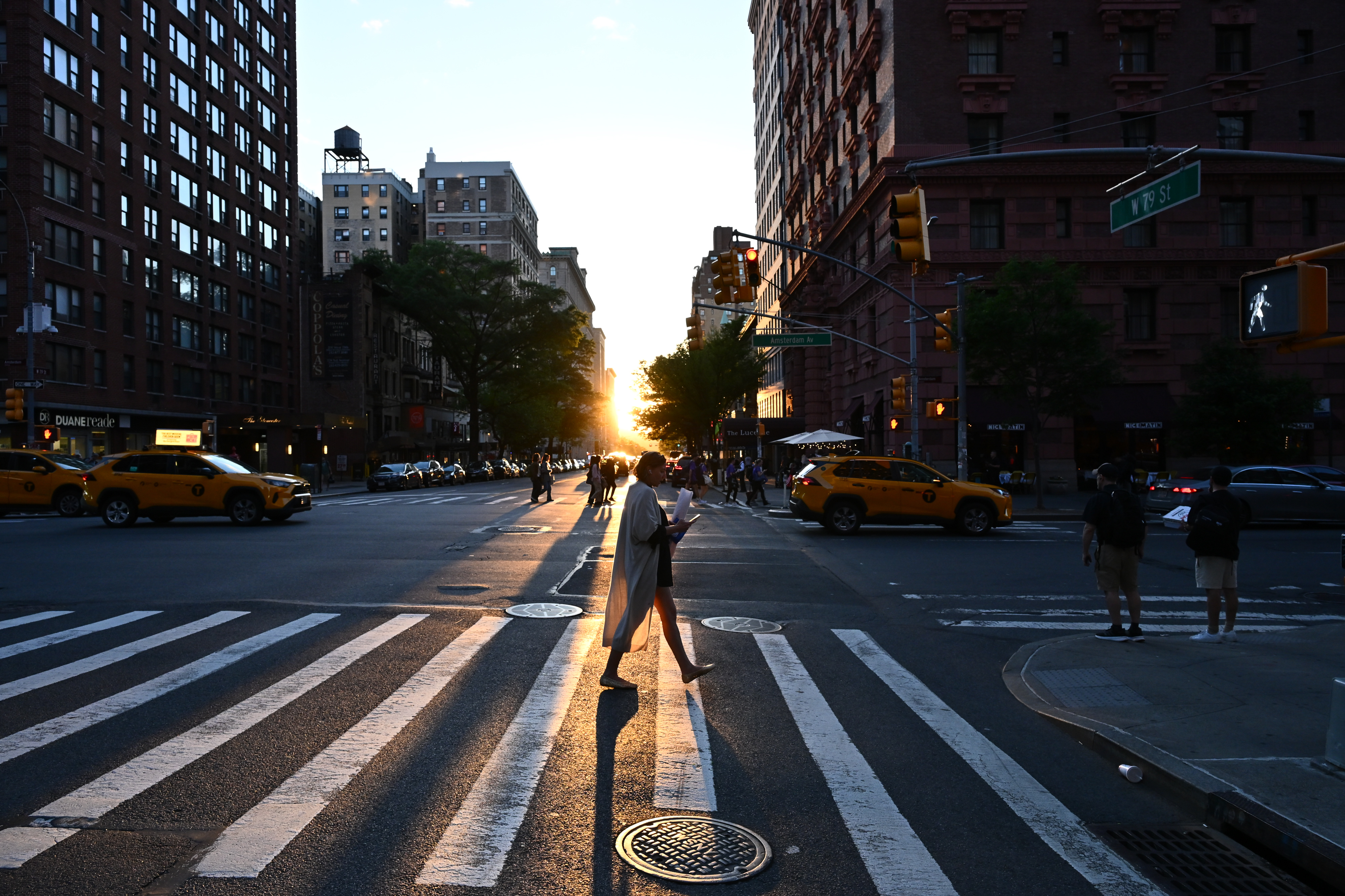 Sunset over the Upper West Side avenue at the corner crosswalk
