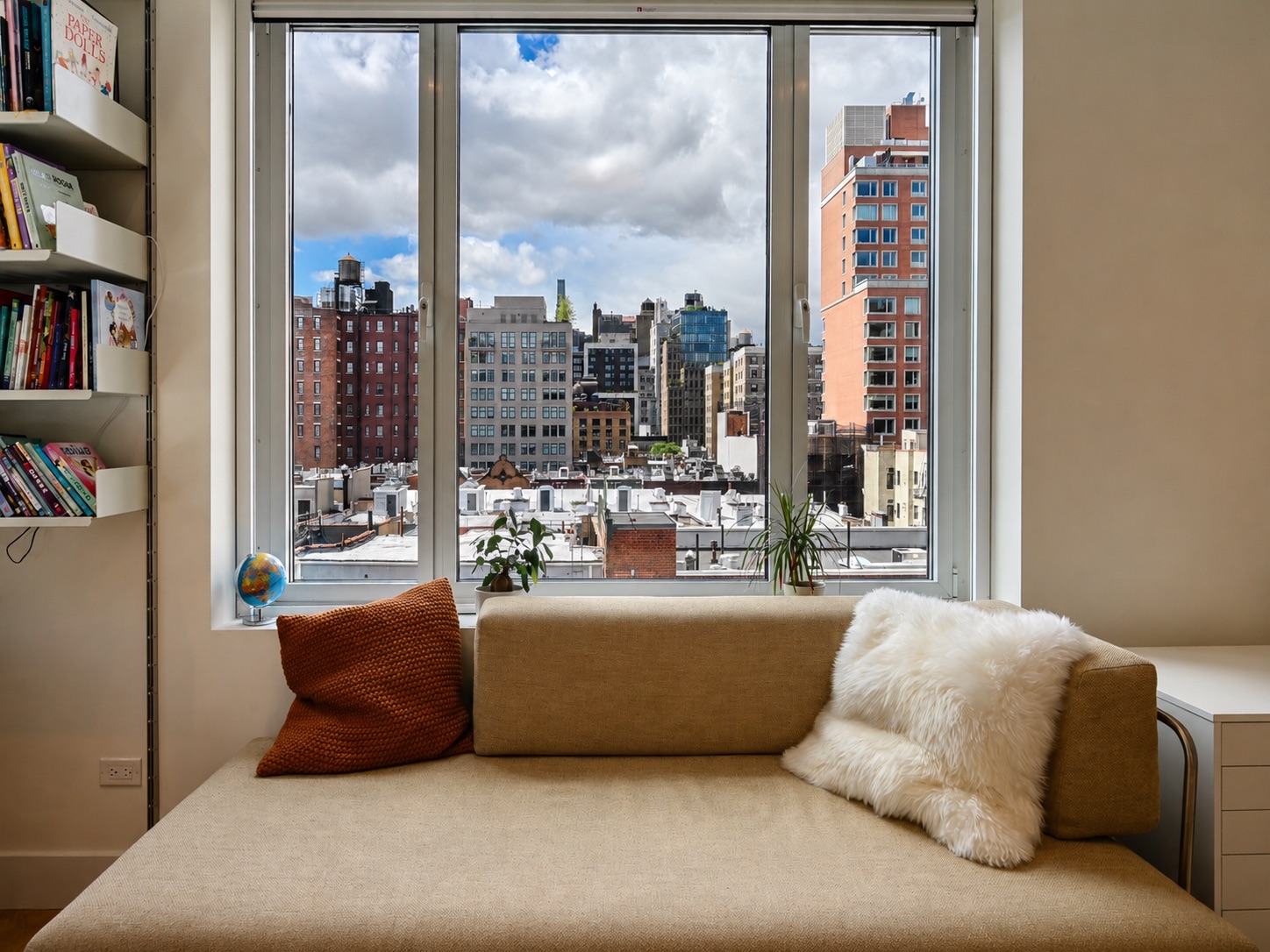 Bright primary bedroom with open city skyline views